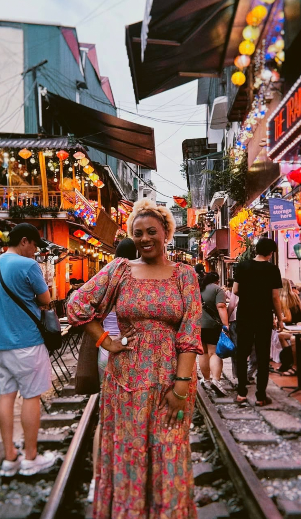 OnJaLee smiling on the Hanoi train street lined with lanterns